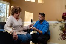 image of a man helping a woman improve her hand grip through physical therapy